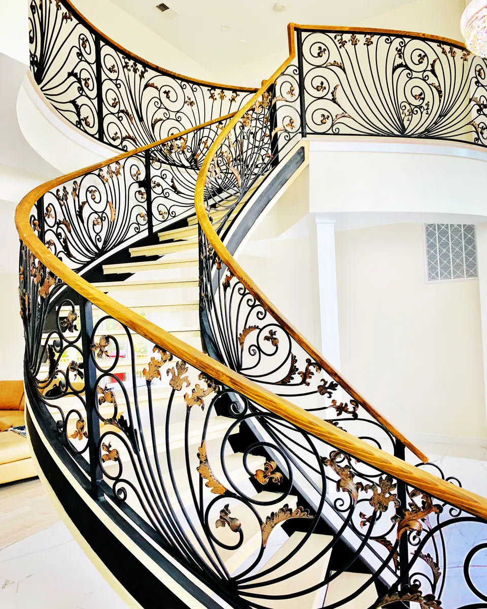 Close view of scroll balustrade with wood handrail on a curved stair