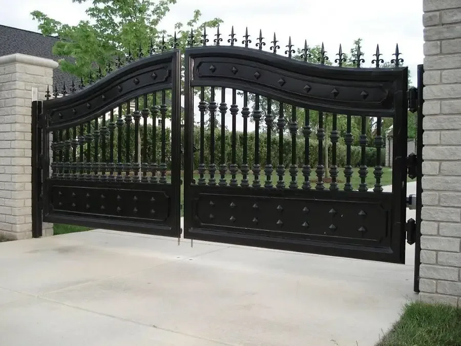 Black metal fence and double gate with decorative pointed finials