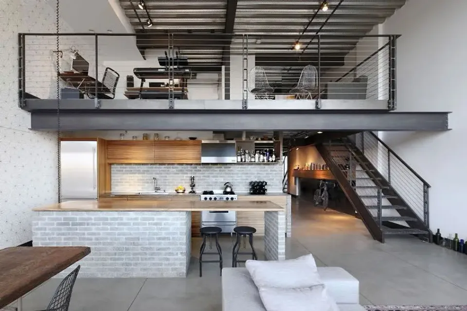 Interior mezzanine with dark metal rails and a staircase at the side
